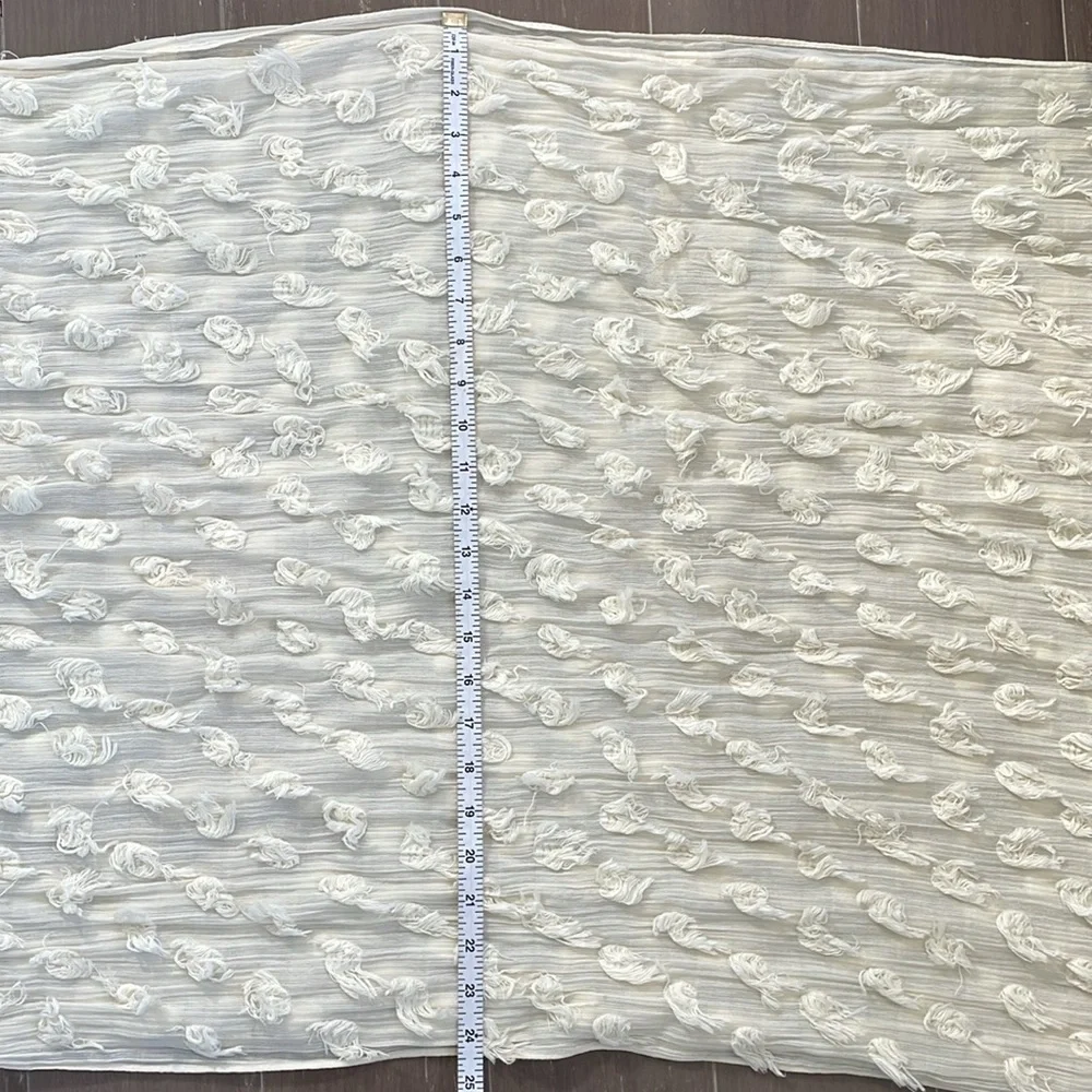 Banana Republic cream lightweight scarf or wrap with Pom Pom ball detail.